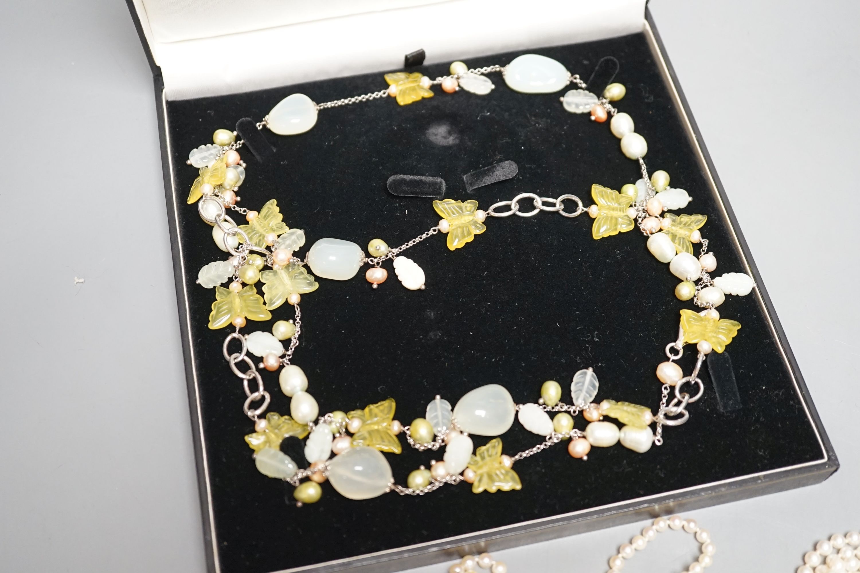 Four cultured pearl necklaces, including one double strand by Mikimoto, 46cm, three with 9ct gold clasps, one cultured pearl bracelet and two modern glass necklaces.